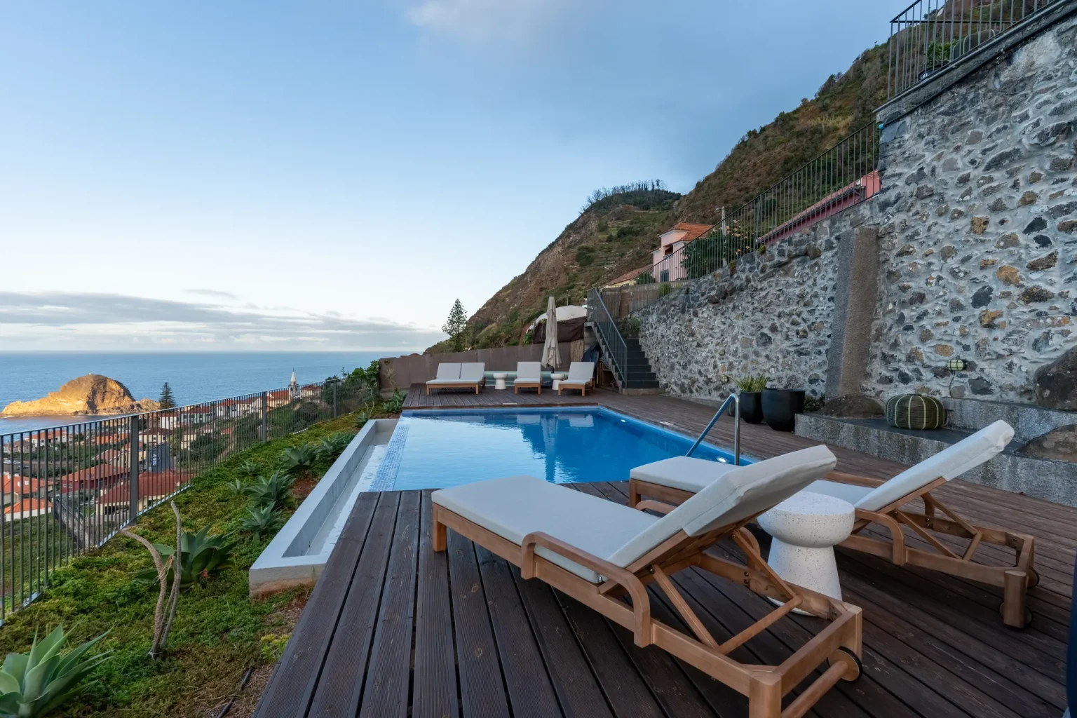 Villa Escaleiras' infinity pool terrace with loungers, overlooking Porto Moniz and its islet