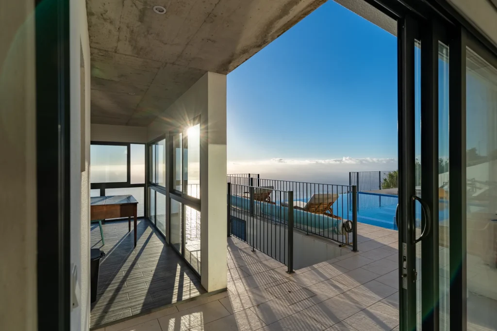 Villa Espigão's terrace corridor between the living room and the infinity pool deck, looking out to sea
