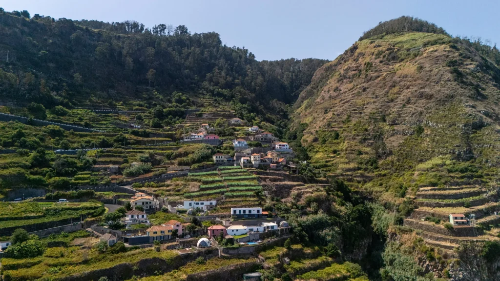 Aerial view of the terraced hillside and scattered houses above Porto Moniz, around Villa Domaterra II